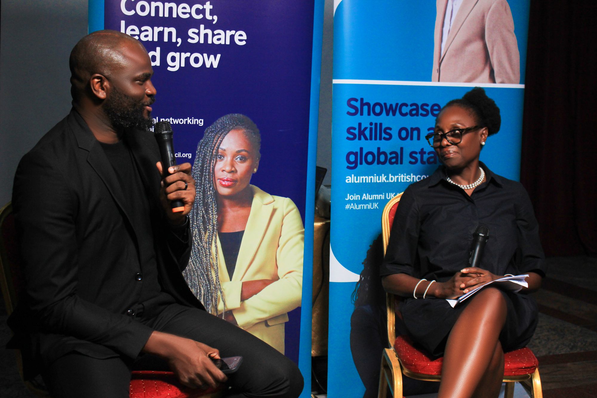 A panel conversation in front of the Alumni UK banners at Landmark Hotels, Port Harcourt
